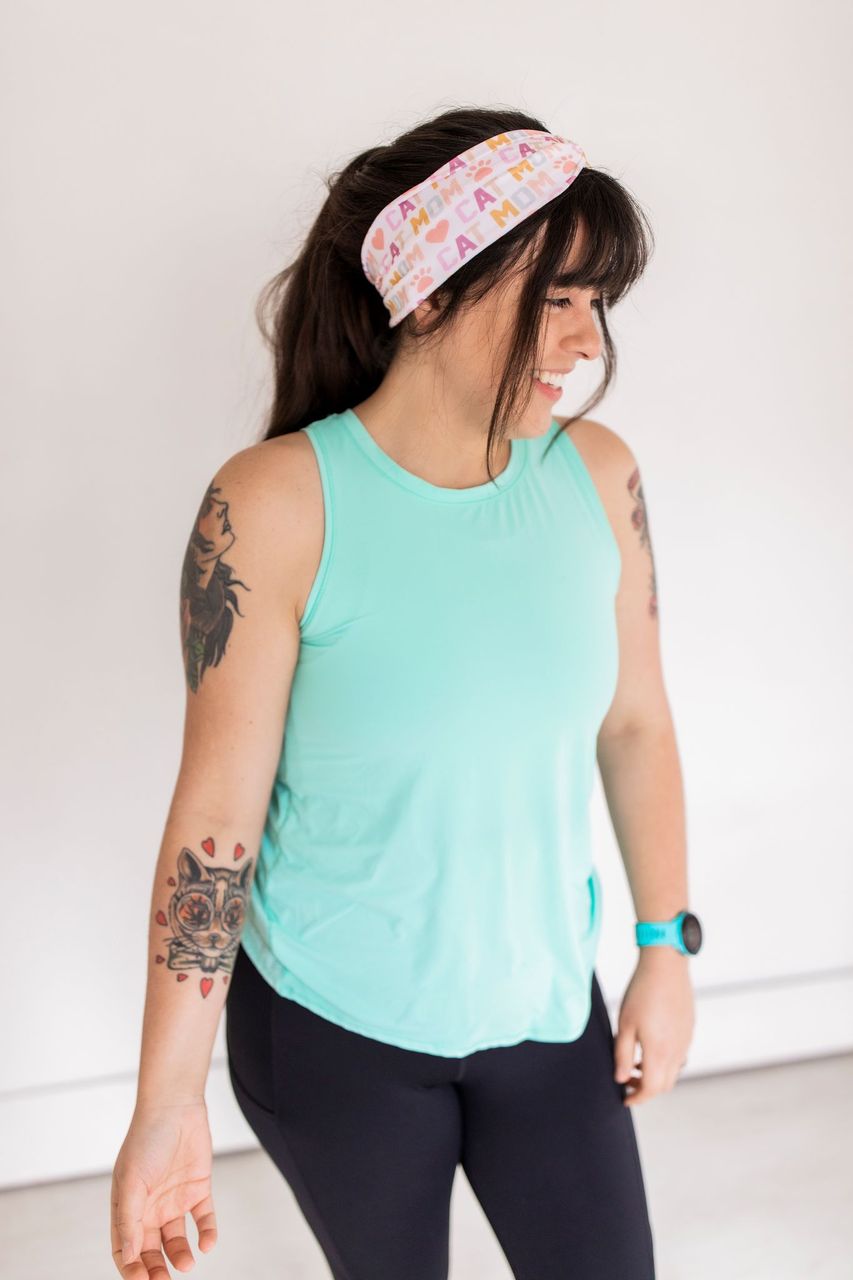 Adult women's white headband with orange, slate, tan, blush and plum pawprints, hearts and words they say "cat mom"