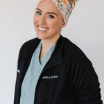 Adult women's ivory headband with watercolor coral, orange, peach and ivory flowers and leaves with the cursive script "I've got you" hidden throughout the print