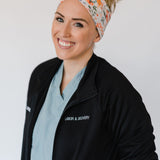 Adult women's ivory headband with watercolor coral, orange, peach and ivory flowers and leaves with the cursive script "I've got you" hidden throughout the print