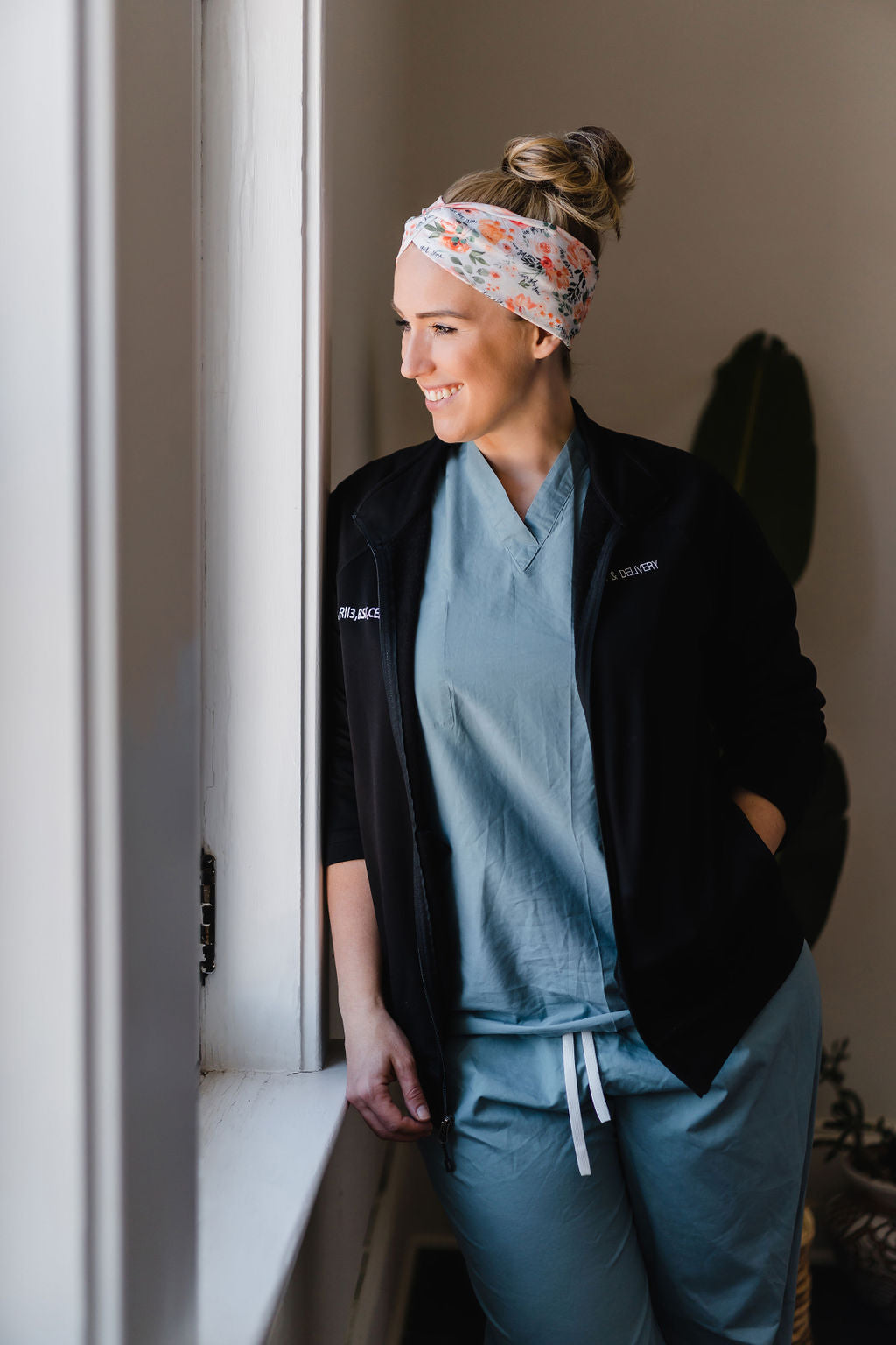 Adult women's ivory headband with watercolor coral, orange, peach and ivory flowers and leaves with the cursive script "I've got you" hidden throughout the print