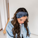 Adult women’s black headband with white paisley bandana print.
