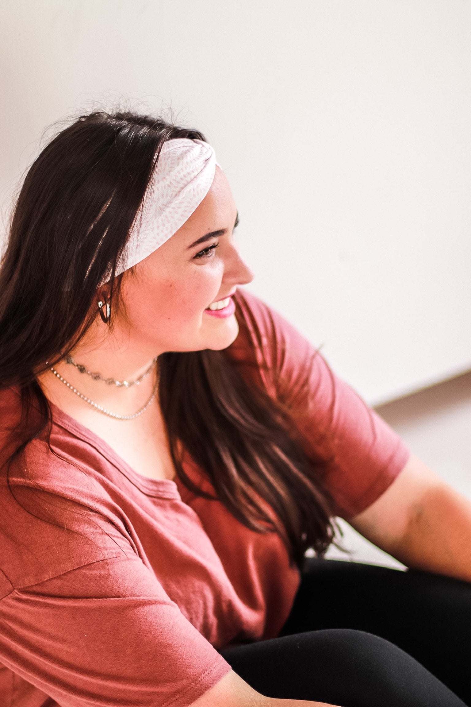Adult women's ivory headband with allover salmon colored tribal dashes in half circle patterns