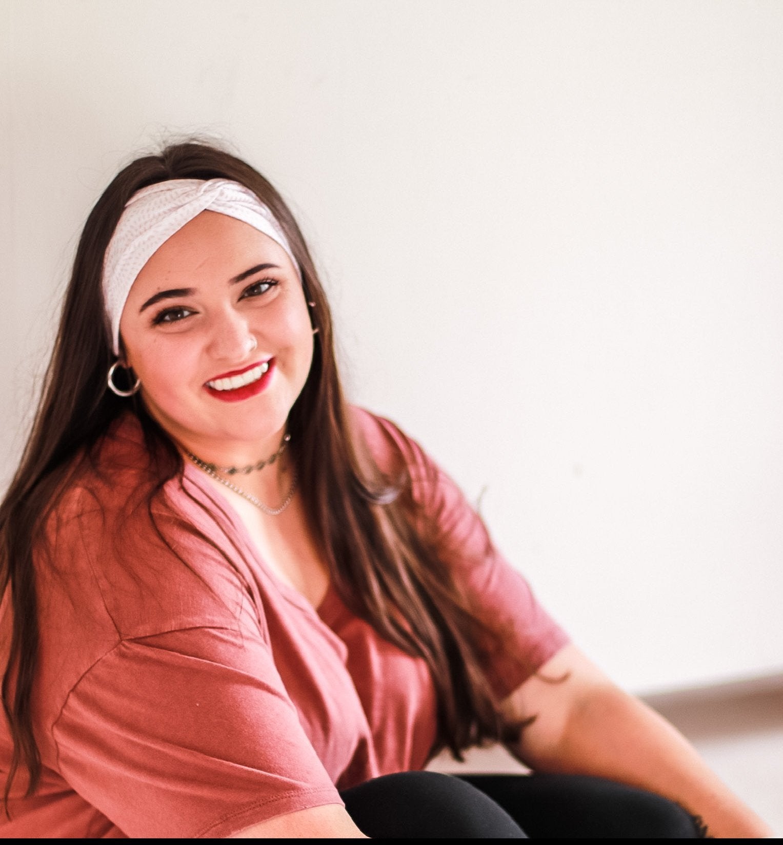 Adult women's ivory headband with allover salmon colored tribal dashes in half circle patterns