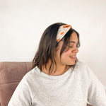 Adult women's white headband with large sunflower and daisy print