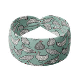 Adult women's light teal headband with allover black and white cartoon chicken print
