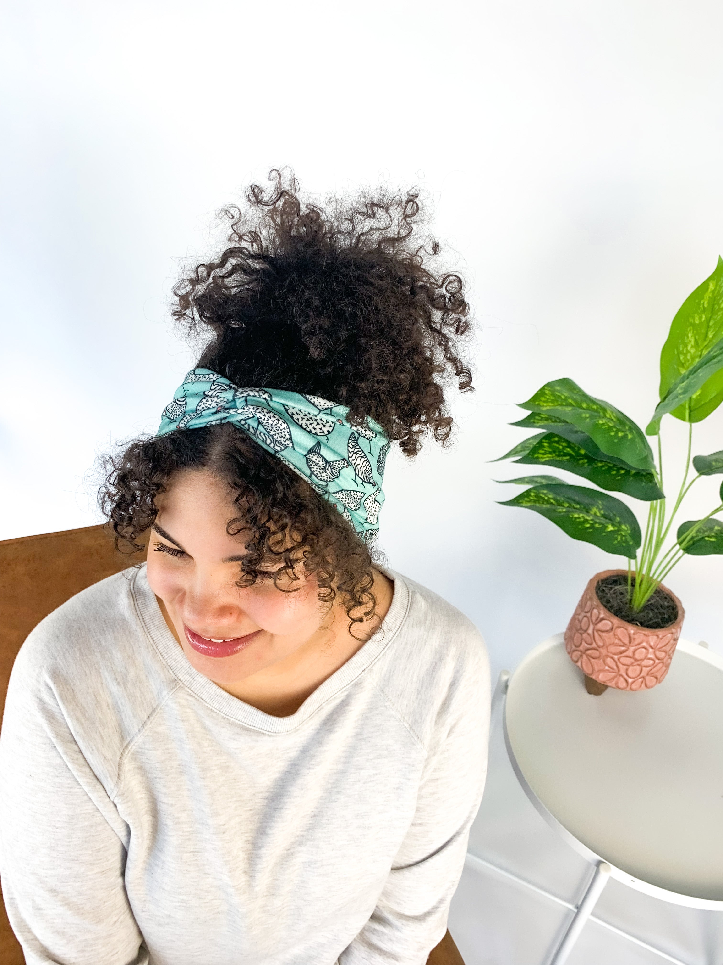 Adult women's light teal headband with allover black and white cartoon chicken print