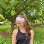 Adult women's ivory headband with soft pink, coral and green watercolor floral print