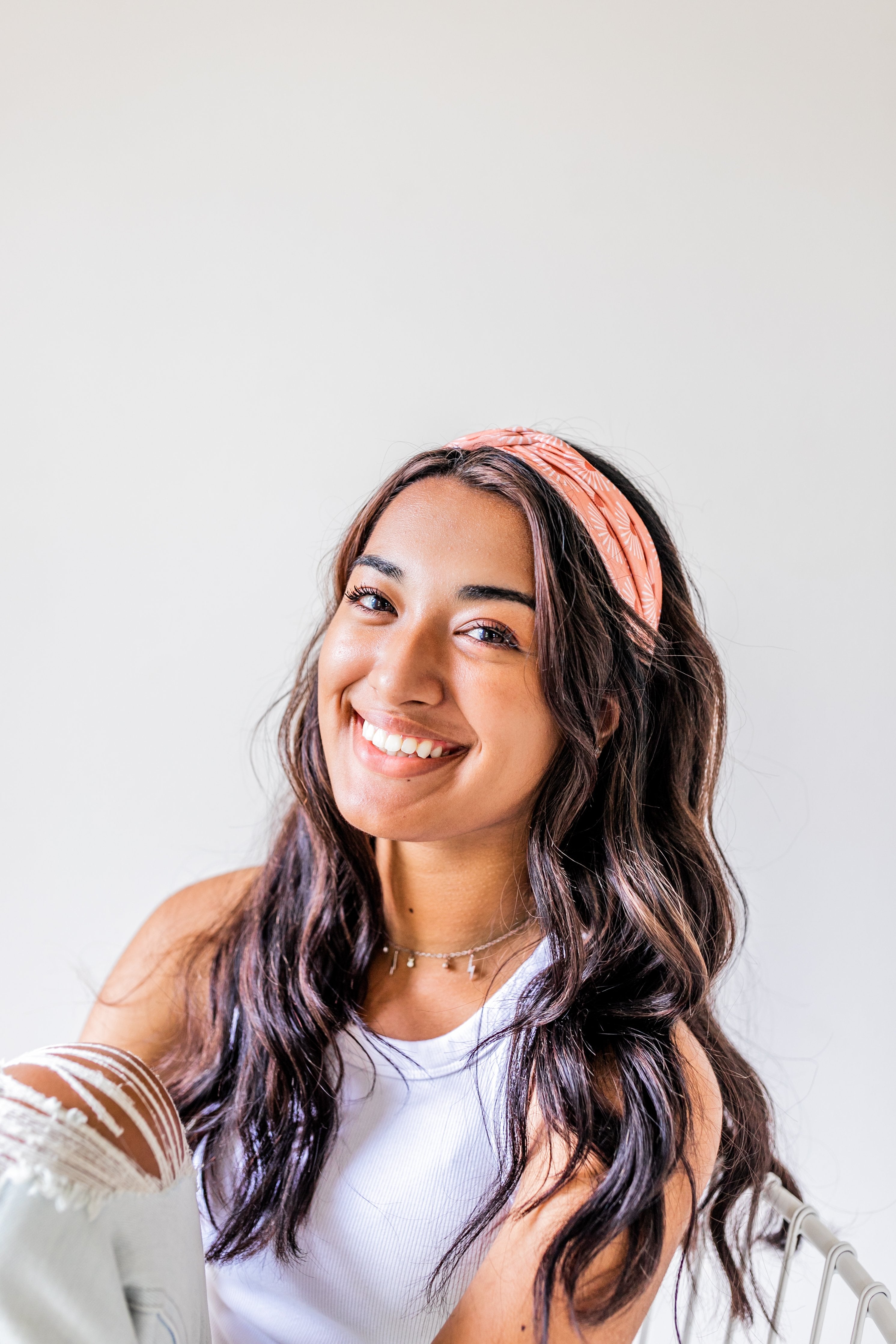 Adult women's burnt orange headband with allover dark orange and white sunsets