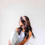 Adult women's burnt orange headband with allover dark orange and white sunsets