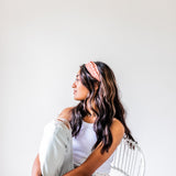 Adult women's burnt orange headband with allover dark orange and white sunsets