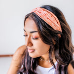 Adult women's burnt orange headband with allover dark orange and white sunsets