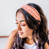Adult women's burnt orange headband with allover dark orange and white sunsets