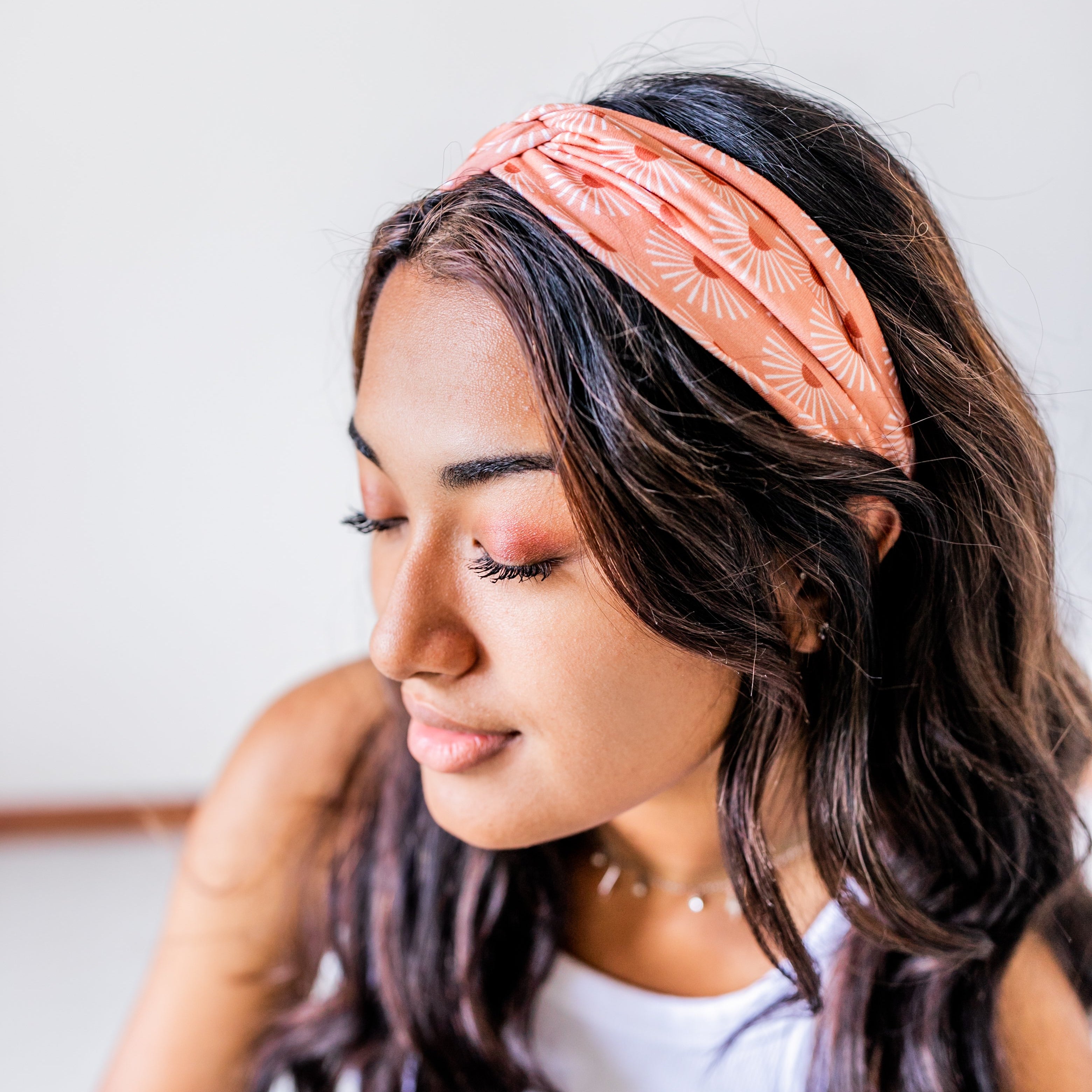Adult women's burnt orange headband with allover dark orange and white sunsets