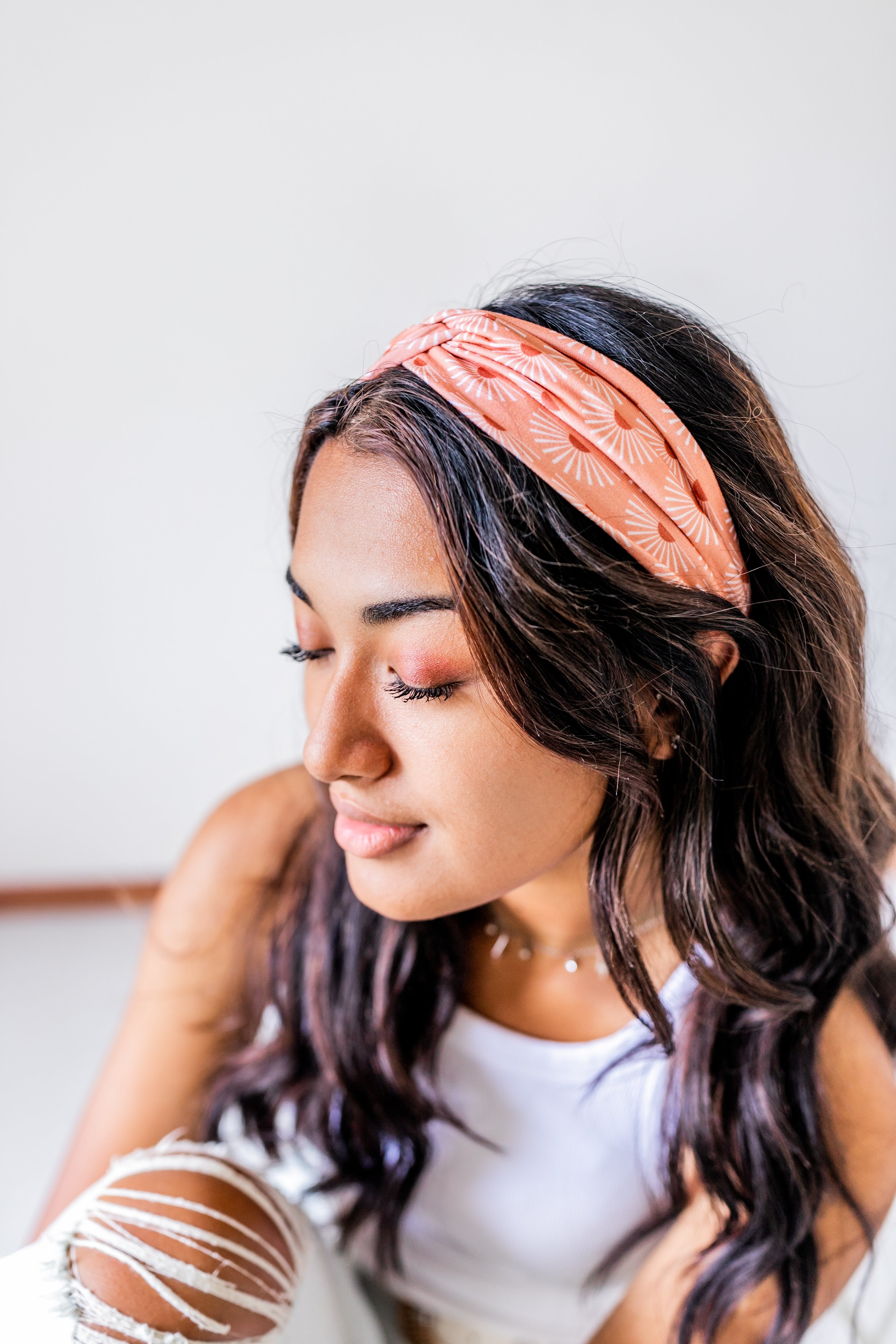Adult women's burnt orange headband with allover dark orange and white sunsets