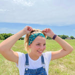 Adult women's dark green headband with yellow corn on the husk with different shades of green leaves