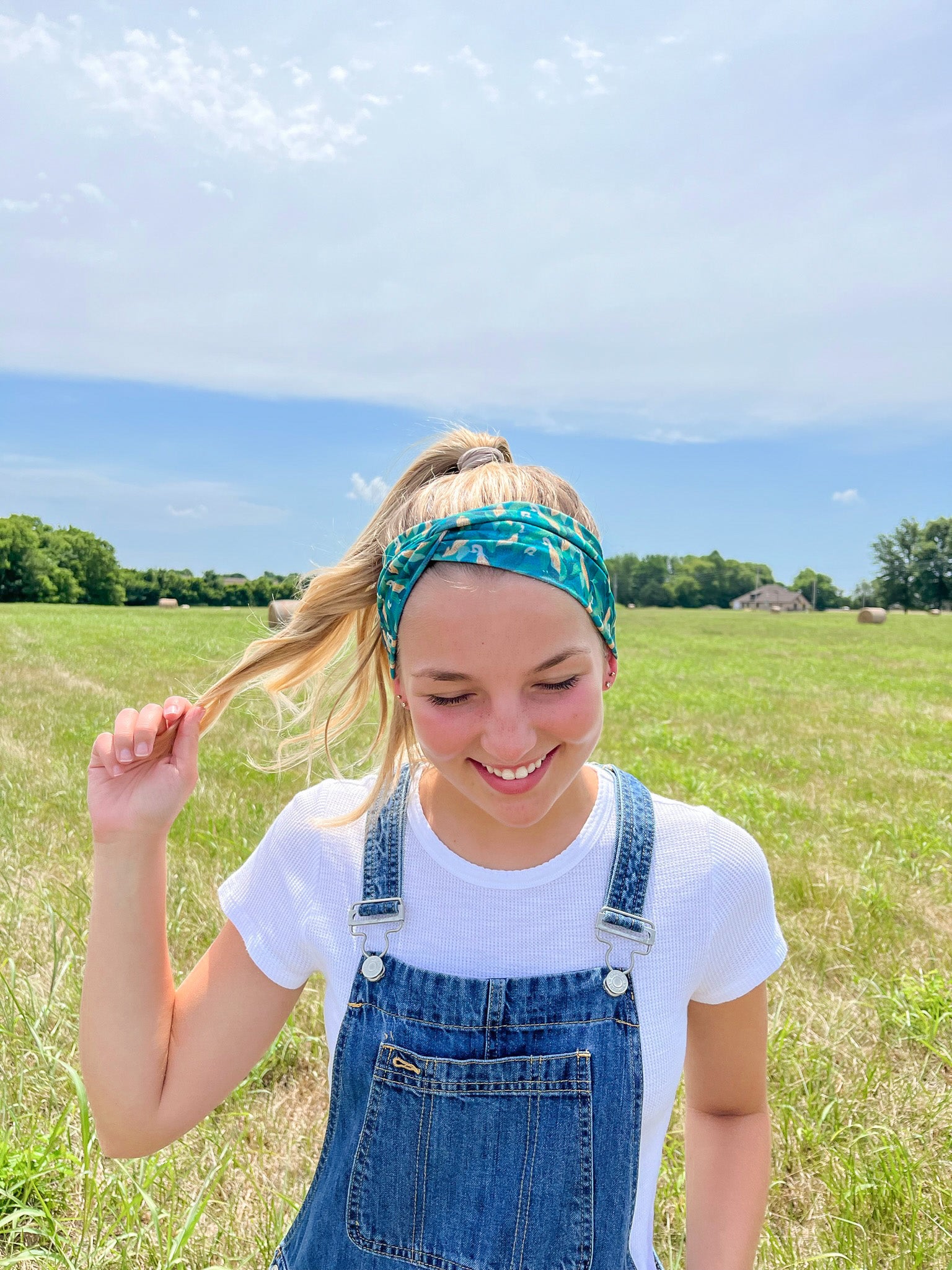 Adult women's dark green headband with yellow corn on the husk with different shades of green leaves