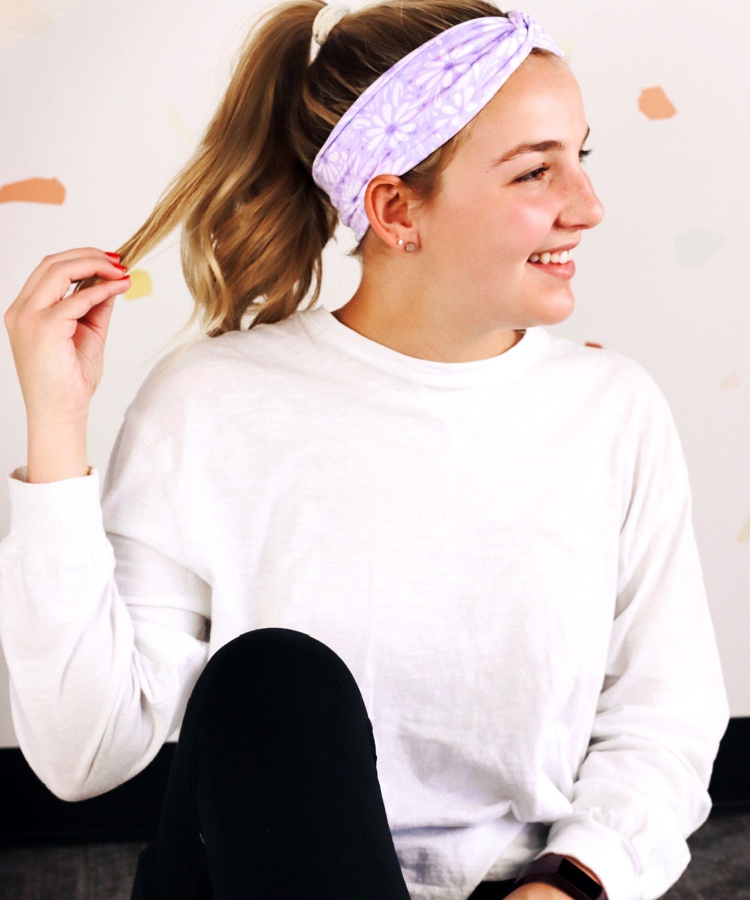 Adult women’s purple headband with medium white, dark and light purple floral allover pattern.