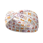 Adult women's white headband with orange, slate, tan, blush and plum pawprints, hearts and words they say "dog mom"