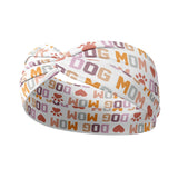 Adult women's white headband with orange, slate, tan, blush and plum pawprints, hearts and words they say "dog mom"