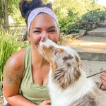 Adult women's white headband with orange, slate, tan, blush and plum pawprints, hearts and words they say "dog mom"