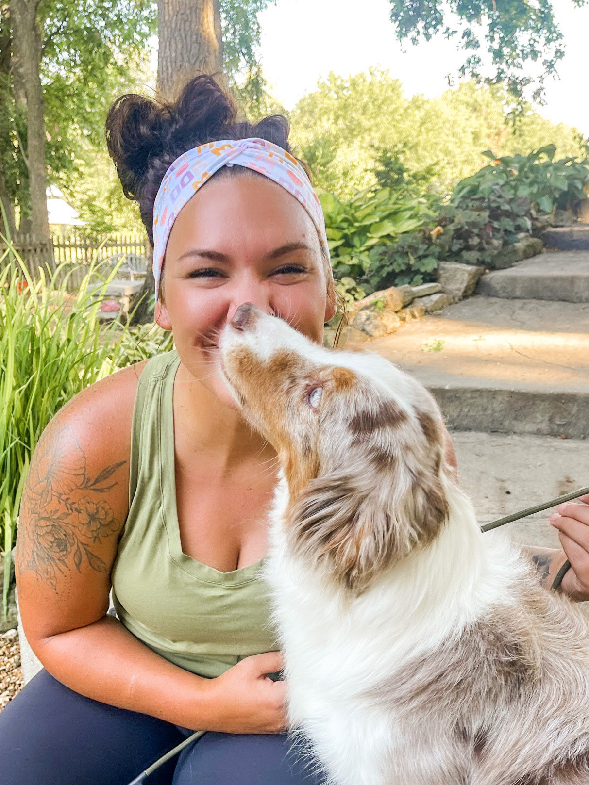 Adult women's white headband with orange, slate, tan, blush and plum pawprints, hearts and words they say "dog mom"