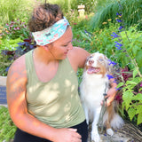 Adult women's aqua headband with drawn Scottish Terriers, Golden Retrievers, Corgis, Dalmations, Bulldogs, Dachsunsds, Weston Terrier and pink flowers allover