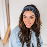 Adult women’s black headband with white paisley bandana print.