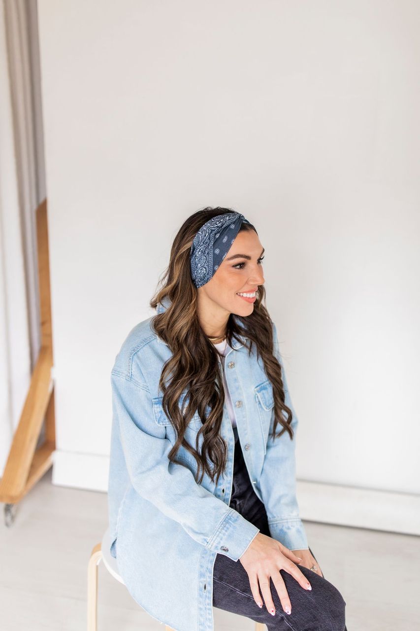 Adult women’s black headband with white paisley bandana print.