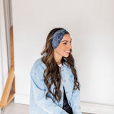Adult women’s black headband with white paisley bandana print.