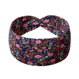 Adult women's black headband with white dancing skeletons and pink, green, red and purple flowers and leaves