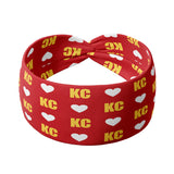 Adult women's red headband with white hearts and bright yellow "KC" pattern