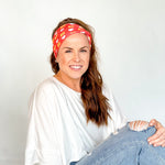 Adult women's red headband with white hearts and bright yellow "KC" pattern