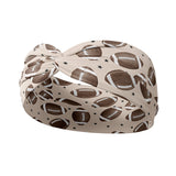 Adult women's tan headband with allover brown footballs and tiny black stars