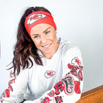 Adult women's red headband with one white arrowhead and red "KC" font in the center