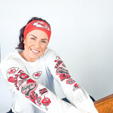 Adult women's red headband with one white arrowhead and red "KC" font in the center