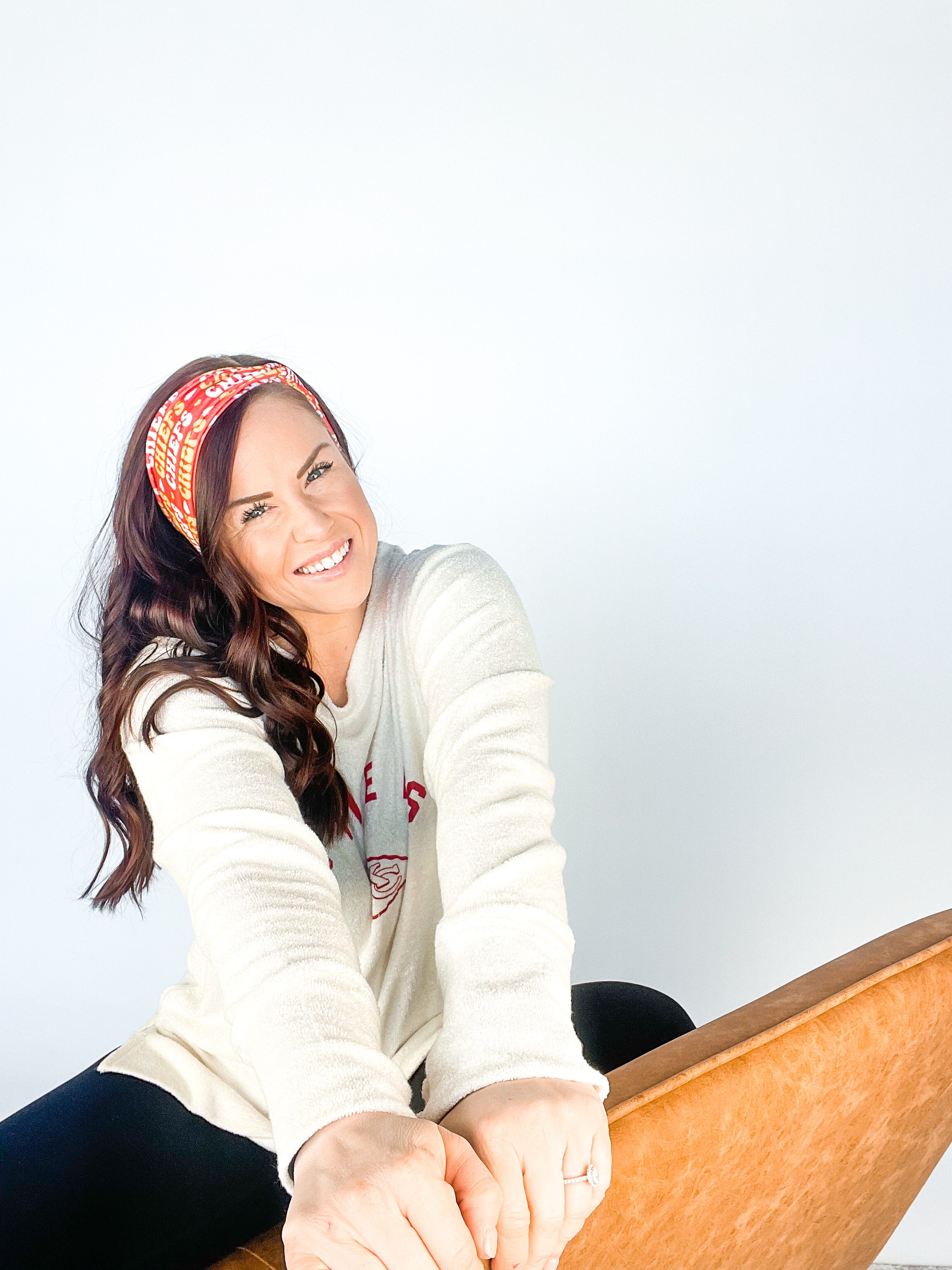 Adult women's red headband with yellow and white 1970's bubble script with the phrase "Chiefs" and an arrowhead
