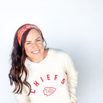 Adult women's red headband with yellow and white 1970's bubble script with the phrase "Chiefs" and an arrowhead
