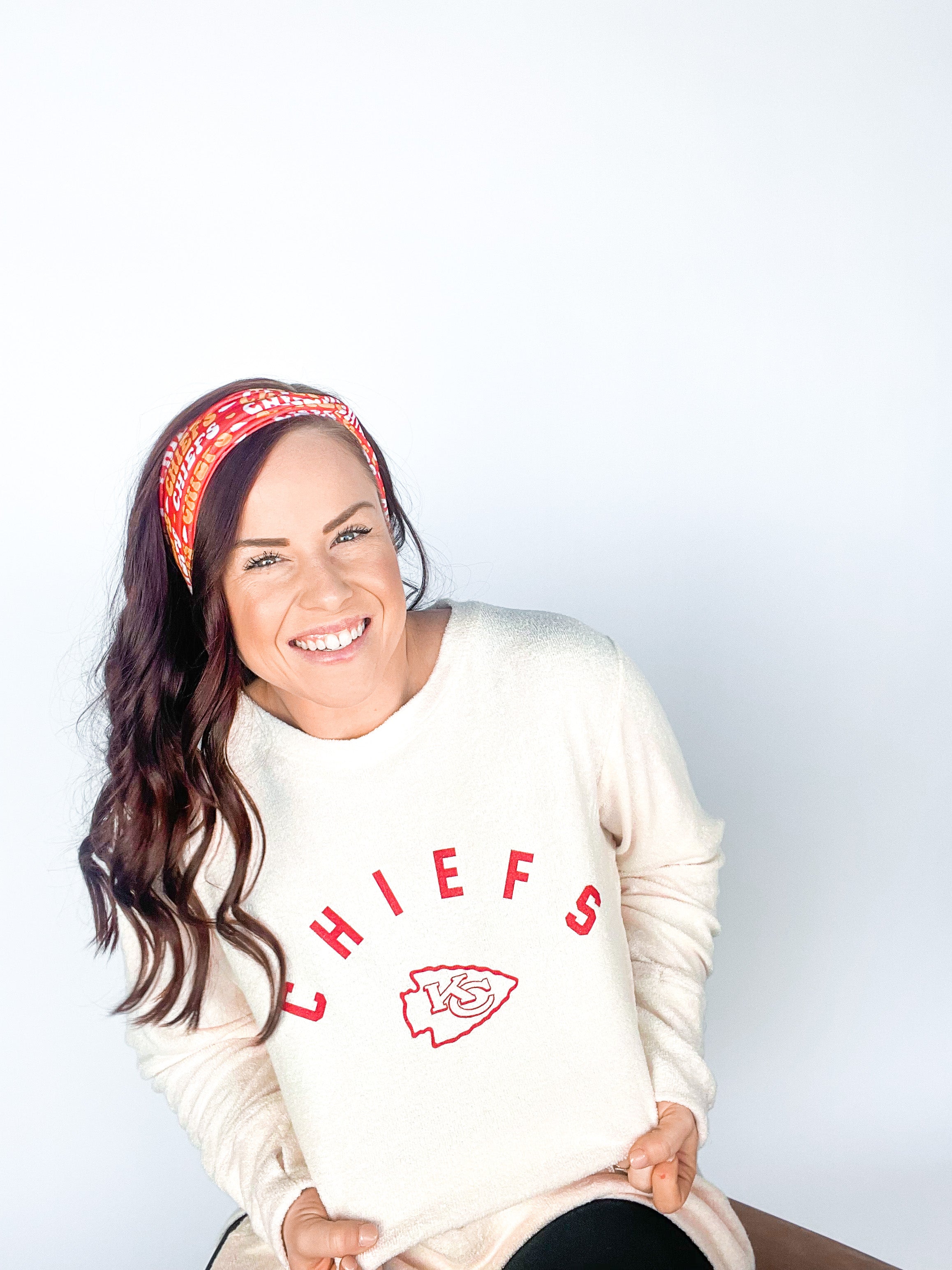 Adult women's red headband with yellow and white 1970's bubble script with the phrase "Chiefs" and an arrowhead