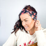Adult women's black headband with yellow, red and white artistic cartoons of Patrick Mahomes, Avery Reid and Travis Kelce