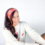 Adult women's red headband with yellow and white 1970's bubble script with the phrase "Chiefs" and an arrowhead