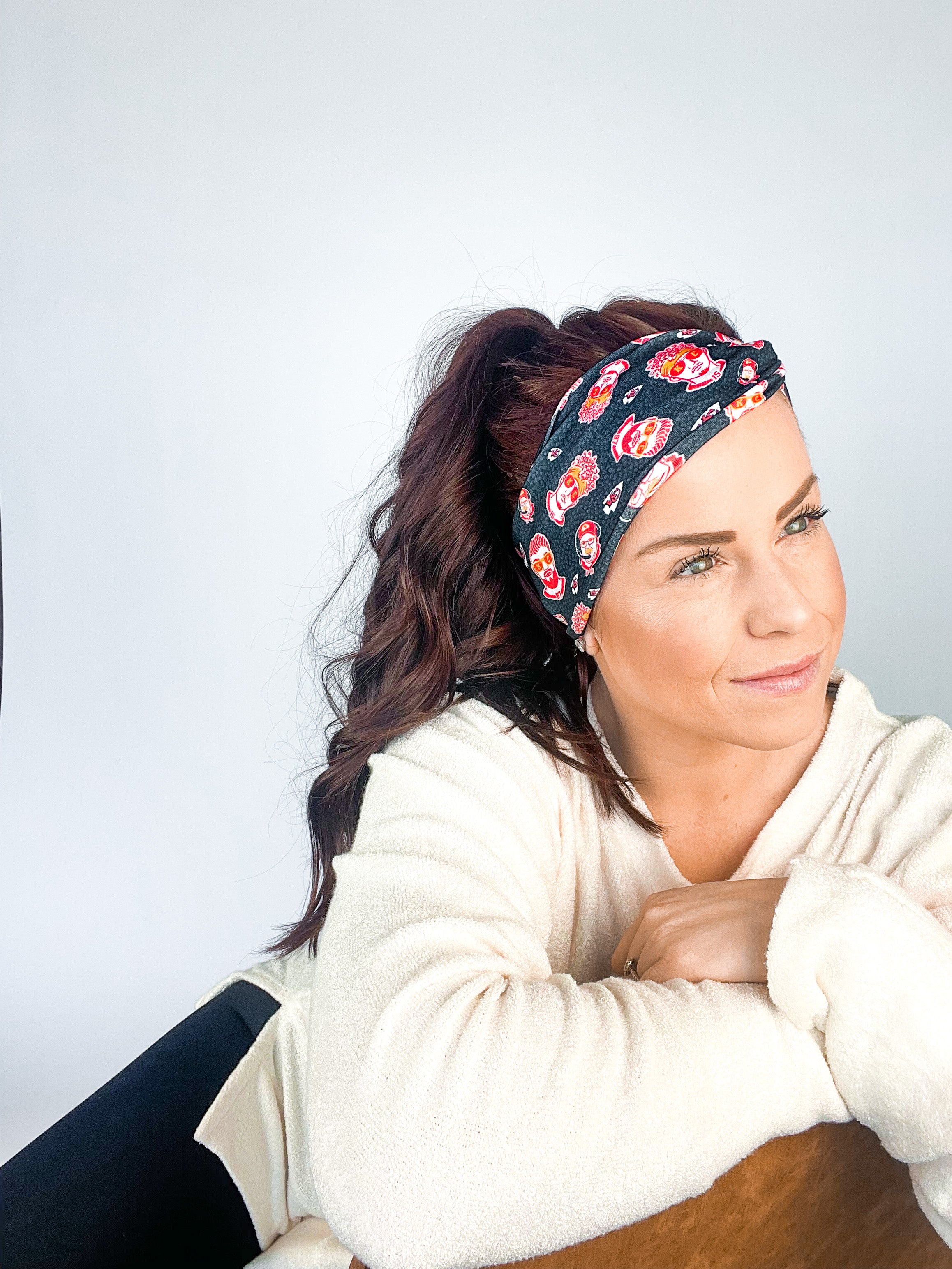 Adult women's black headband with yellow, red and white artistic cartoons of Patrick Mahomes, Avery Reid and Travis Kelce