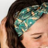 Adult women's dark green headband with yellow corn on the husk with different shades of green leaves
