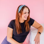 Adult women's emerald green headband with skeleton hands signing love, peace, rock-on and hang-loose shaka sign with yellow lightneing bolts and orange and pink diamonds