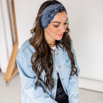Adult women’s black headband with white paisley bandana print.