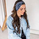 Adult women’s black headband with white paisley bandana print.