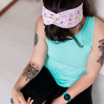 Adult women's white headband with orange, slate, tan, blush and plum pawprints, hearts and words they say "cat mom"