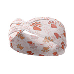 Adult women's ivory headband with blush, tan and orange pawprints and tiny dots