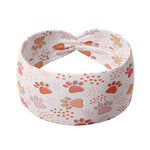 Adult women's ivory headband with blush, tan and orange pawprints and tiny dots