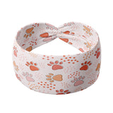 Adult women's ivory headband with blush, tan and orange pawprints and tiny dots