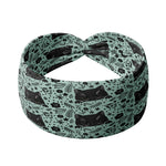 Adult women's sage headband with black cat art peaking over with small black flower and dot outlines